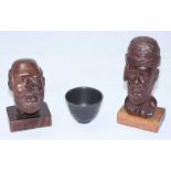 Two carved hardwood heads, one signed 'L. Bryan' (Lancelot Bryan?) to base, together with a