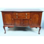 An early 20th century mahogany sideboard with two drawers over a cupboard flanked by two further