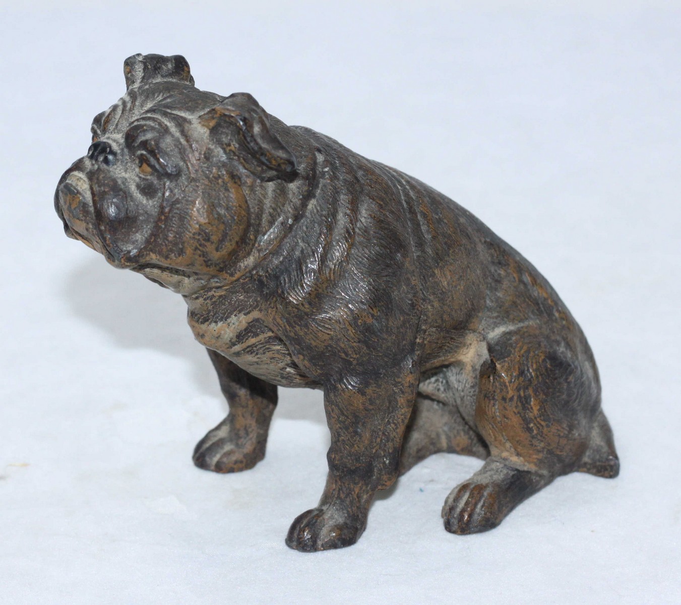A late 19th century cold-painted hollow-cast spelter figure of a seated Bulldog