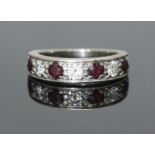An 18ct white gold ring, the top set with alternating stones, three diamonds and four ruby