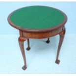 An early 20th century walnut demi-lune, folding card table, the top lifting to reveal a green