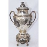 A silver-plated samovar, with cover, twin handles and raised on small cabriole supports. 43cm high.