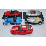 Five assorted modern scale model sports cars, including a Porsche 911 and a Dodge Viper etc.