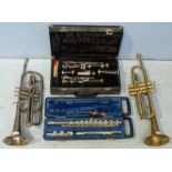 A cased Yamaha flute and a cased Artley clarinet, together with two various trumpets.