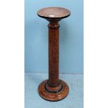 A torchere stand, the circular top raised on reeded column to a turned base, all over painted with