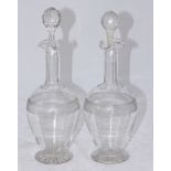 A pair of glass decanters, the ovoid bodies with applied decoration to circular spreading foot and