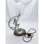 A 1930's aluminium table lamp modelled as an athletic figure in profile. 47cm high.