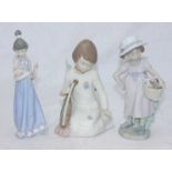 Two boxed Lladro ceramic figures of girls with baskets of flowers, together with a boxed Nadal