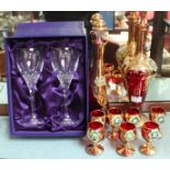 A Venetian ruby and gilt-glass liqueur set with raised polychrome floral decoration, comprising