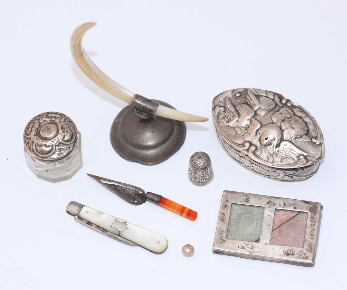 A small silver embossed oval box, London, 1902, maker's mark WC, together with a silver thimble,