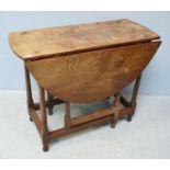 An 18th Century oak oval drop-leaf dining table, with single frieze drawer, block-and-turned