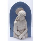 A Della Robbia type pottery wall plaque of Jesus Christ, moulded in high relief, with arched top,