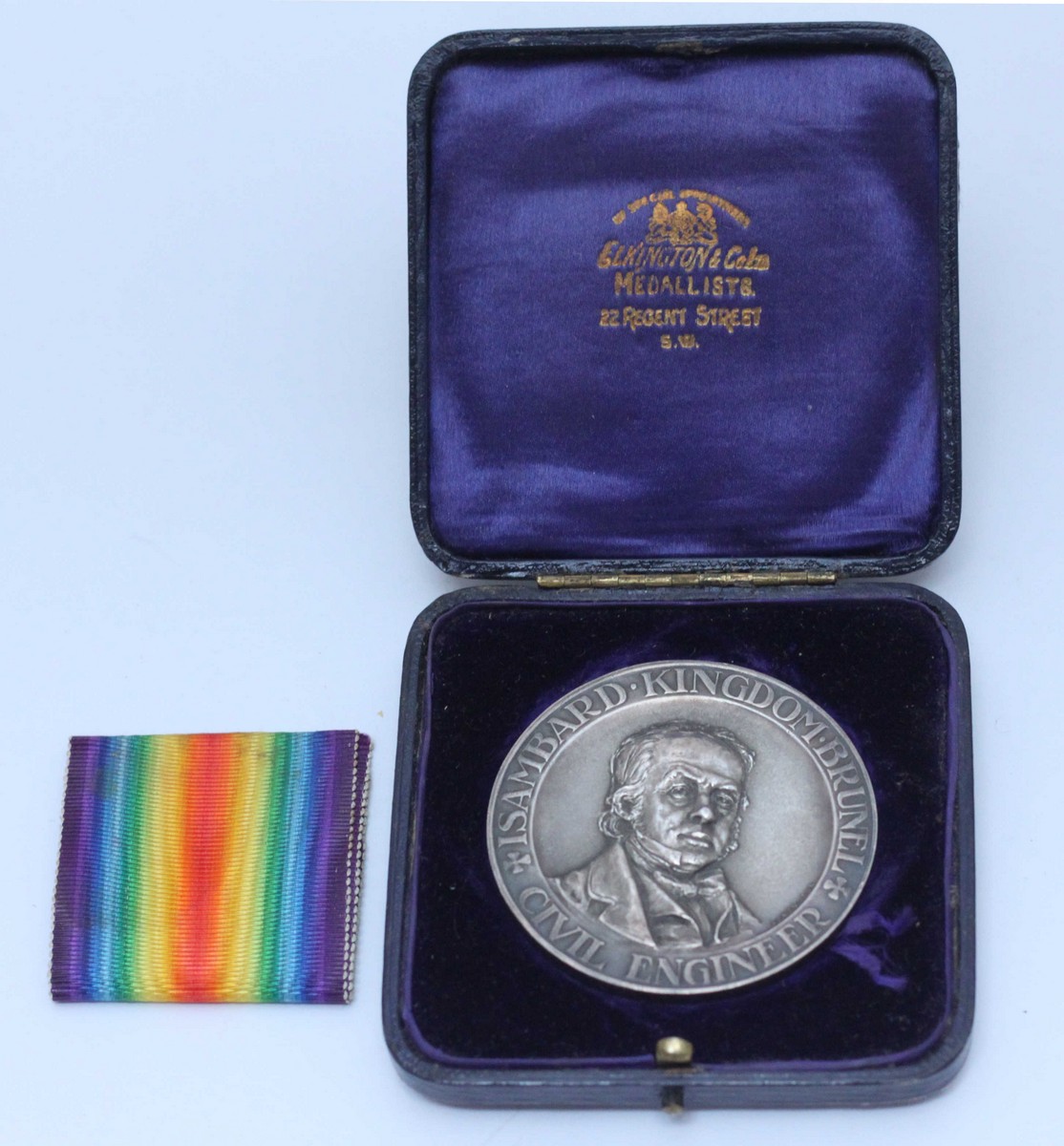 London School of Economics, a silver award medal by Elkington, with relief moulded bust of