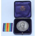 London School of Economics, a silver award medal by Elkington, with relief moulded bust of