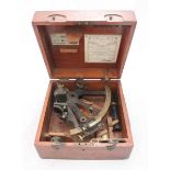 An early 20th century brass marine sextant by E R Watts & Son, London, in original fitted mahogany