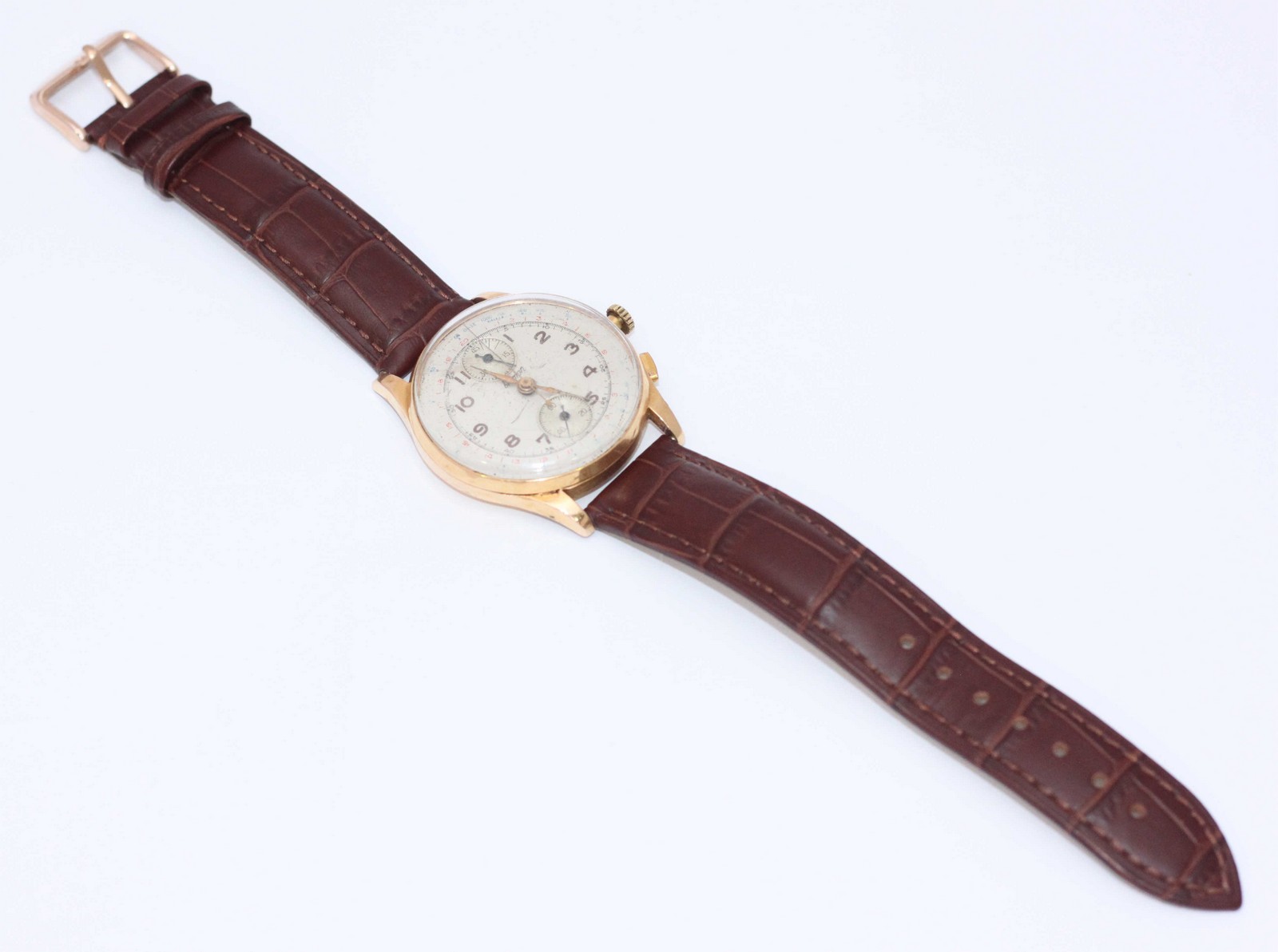 A 1950's gold Bremon chronograph wrist watch, the silvered dial with Arabic numerals denoting
