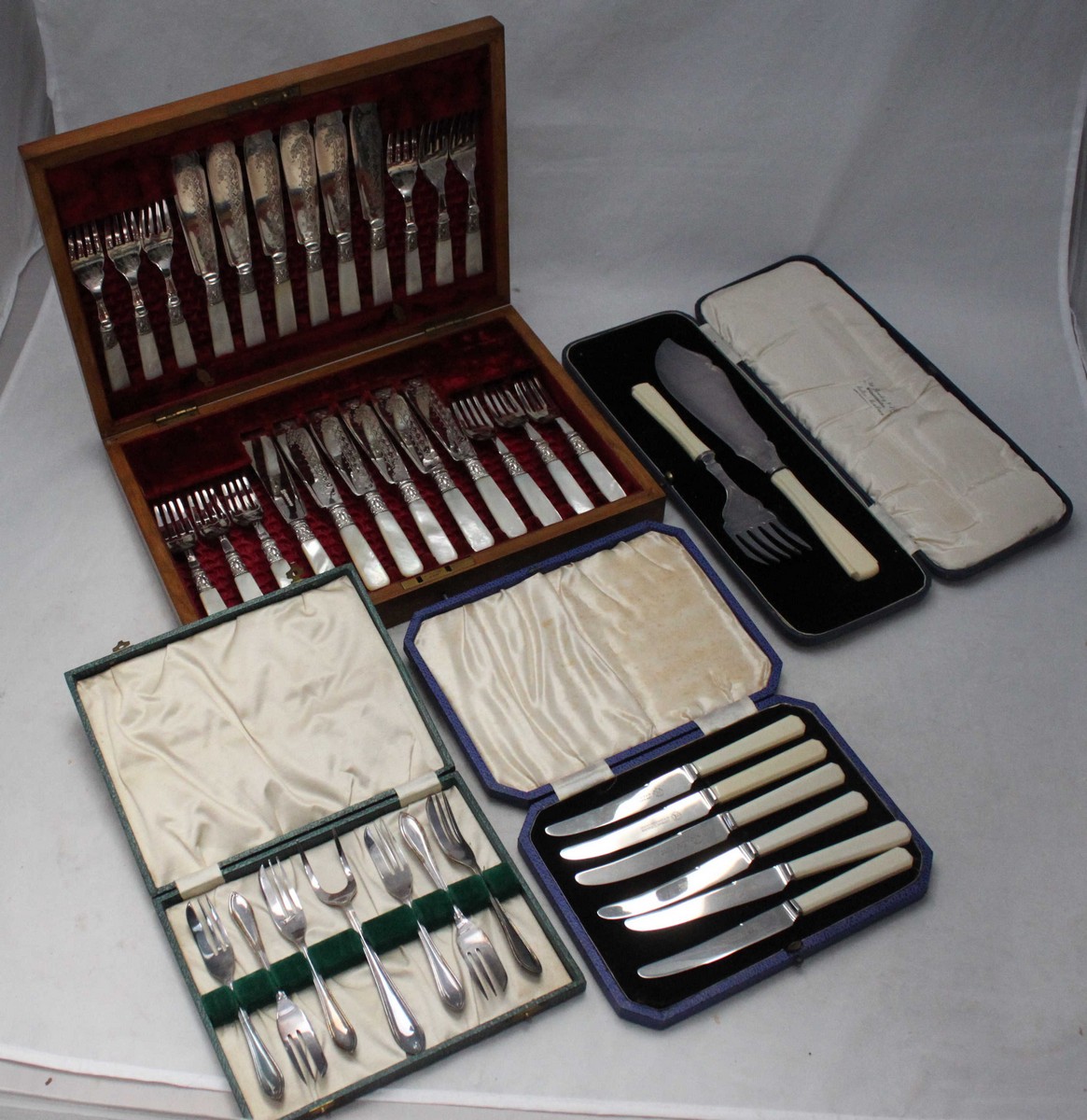 A good quality 12-place fish eating set with mother-of-pearl handles and engraved silver-plated