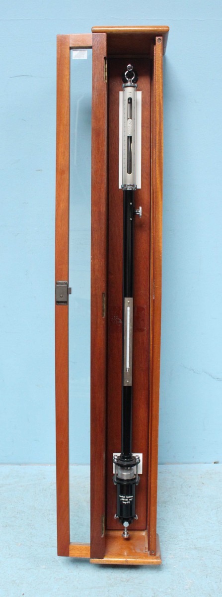 A Fortin scientific stick barometer, black enamelled body, in original glazed stained wood hanging