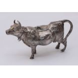 A late 19th century novelty silver cow creamer by B Muller, the standing cow wearing a collar and