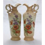 A pair of Victorian Carlsbad Austrian blush ivory ewers with shaped rims and pierced handles, red