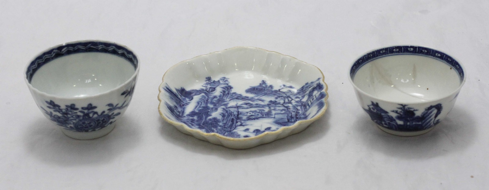 Two 18th century Chinese blue and white porcelain tea bowls and a dish, together with a print of The