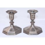 A pair of squat silver candlesticks by Hawksworth Eyre & Co. Ltd, with splayed, octagonal loaded