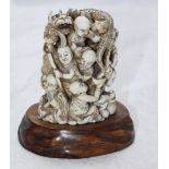 A Japanese Meiji period carved okimono figure group carved as a stack of monk intertwined with a