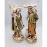 A pair of 19th century Royal Dux porcelain figures of a male and female Persian water carrier,