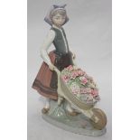 A Lladro ceramic figure-group 'A Barrow of Blossoms' model number '1.419' in original box. 23.5cm