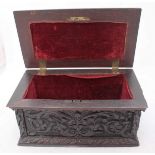 A 19th century carved and fumed oak casket of rectangular form, the whole carved with fruiting