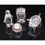 Four boxed Swarovski crystal items including a figure of a pig and one of a penguin etc.