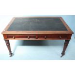 A Victorian mahogany writing table with inset black leather panelled top and two frieze drawers,