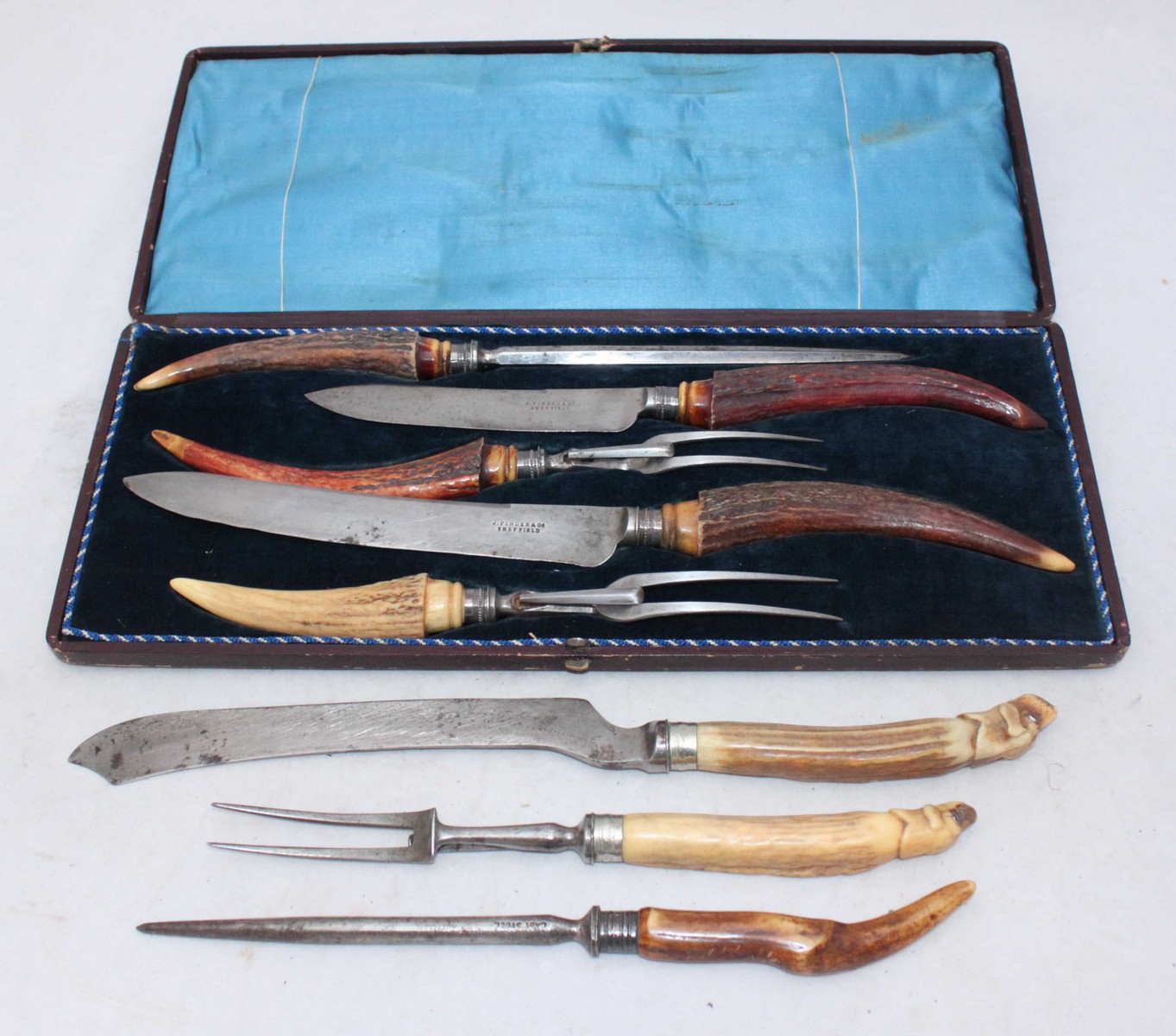 A Victorian five-piece meat carving set with antler handles and silver ferrules, Sheffield, 1866, in