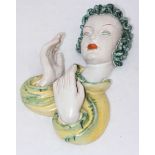 A Goldscheider pottery wall mask modelled as a lady smoking a cigarette. 34cm in length. (