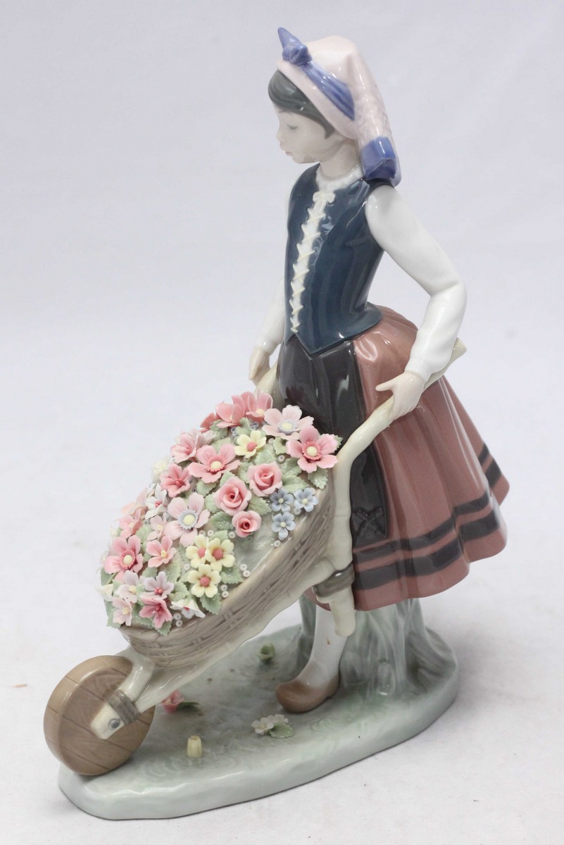 A Lladro porcelain figure 'A Barrow of Blossoms' no.1419. 26cm high.