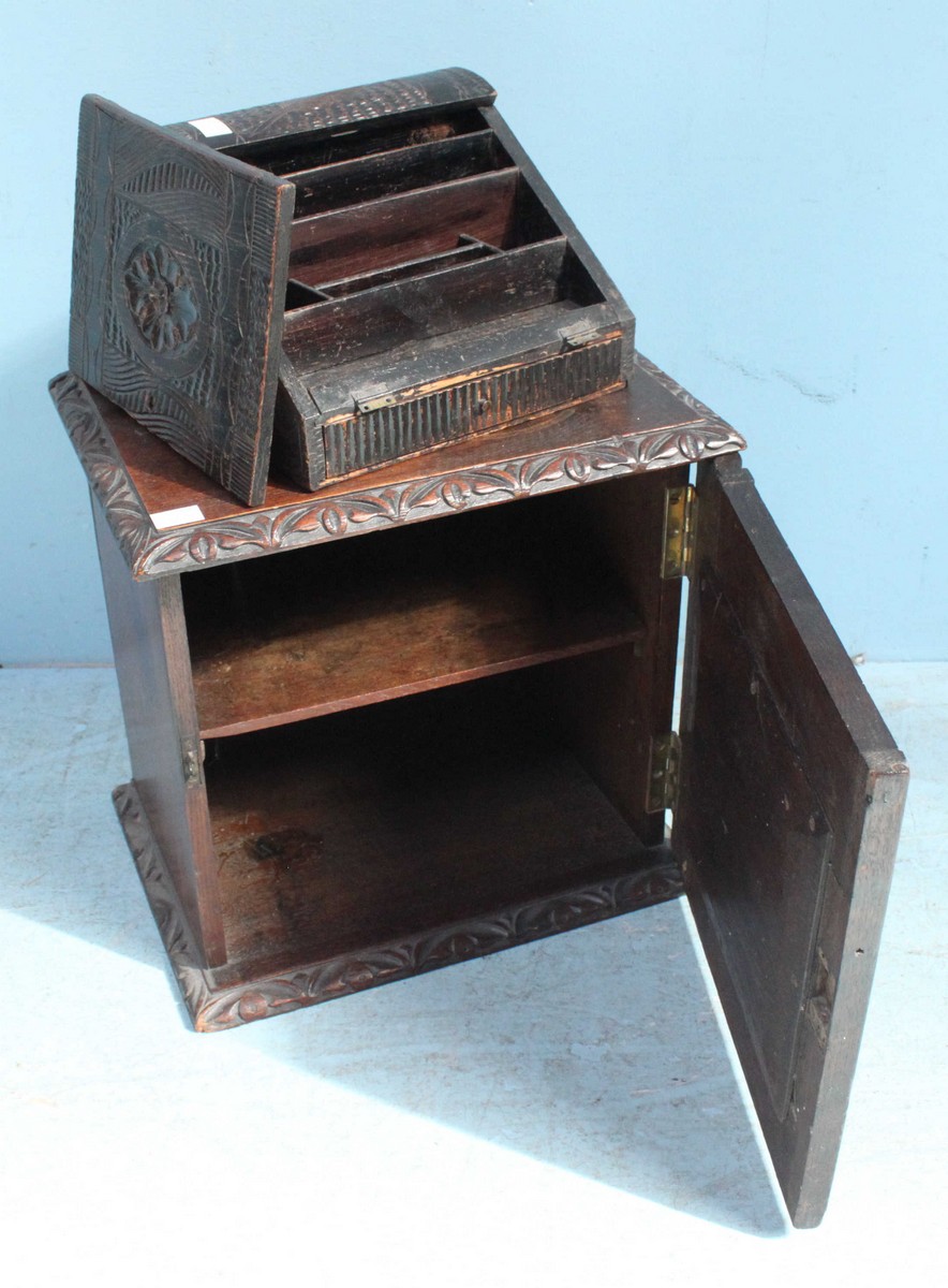 A Victorian carved and stained oak hanging single-cupboard together with a stained and carved oak