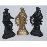 Two pair of cast iron doorstops and a brass doorstop cast as a sailor standing against a ship's