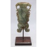 An antique Chinese carved jade vase of rectangular section, with carved dragon handles and