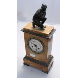 A marble and bronze mantle clock, the top surmounted with a bronze figure kneeling on a shell, to