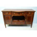 An Edwardian and cross-banded bow-front sideboard with three frieze drawers above a central open