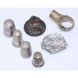 A silver thimble, Chester, 1899, maker's mark of Charles Horner, together with three various white