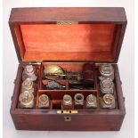 A late 19th/early 20th century mahogany apothecary box with glass bottles, together with military