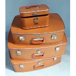 A vintage four-piece luggage set by Coronet, tan, the two large suitcases measuring 23x53x75, a