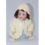 An Armand Marseille doll with jointed composite body, arms and legs, bisque head and sleeping