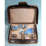 A ladies' eight-piece travelling dressing table set by 'Adie Bros', comprising of three silver and