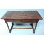 An antique oak side table, with two frieze drawers, raised on turned supports with central