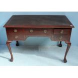 An early 20th century stained walnut dressing table, converted to a writing desk with inset,