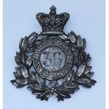 A white metal helmet plate for King's Own 36th Overseas Volunteers