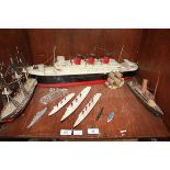 A Triang die-cast model M.703 RMS Queen Mary and M705 Aquitania, together with a Dinky Queen Mary, a