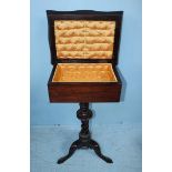 A Victorian mahogany tripod work table, the hinged, galleried tray top opening to reveal a quilted